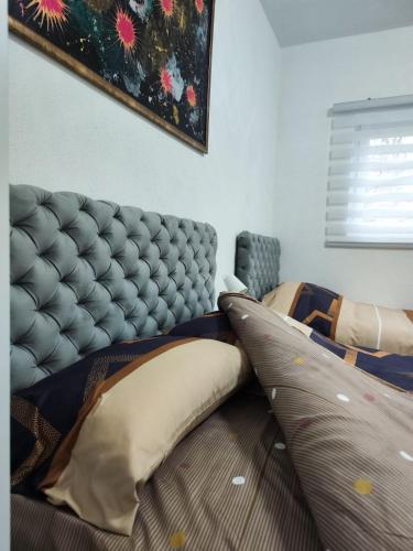 a bedroom with a bed with two pillows on it at Apartmani Valterova in Prijepolje