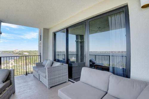 a living room with two couches and a balcony at Florencia 505 in Pensacola