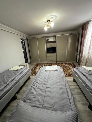 an empty room with two beds in it at 1977 GUEST house in Karakol