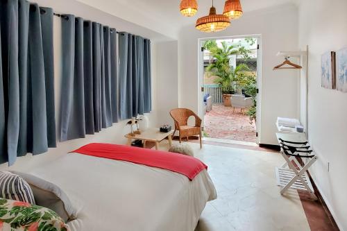 a bedroom with a bed and a door to a patio at Casa Tortuga Ocean Park Villa in San Juan
