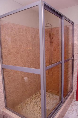 a glass window with a shower in a bathroom at Lovely 3 bedroom Villa in Ikorodu