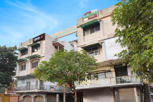 a building with a sign on the side of it at Hotel O Kanchan Palace in Ahmedabad