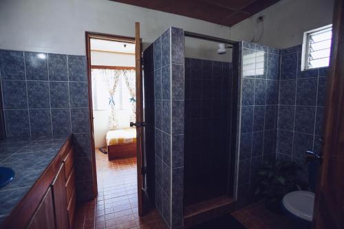 a bathroom with a shower and a sink and a toilet at Spanish by the River - Boquete in Boquete