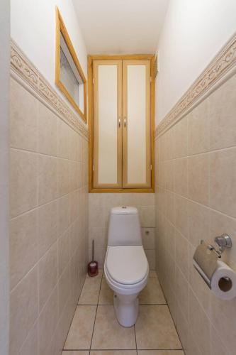 a small bathroom with a toilet and a window at Cheap Apartments in Kyiv