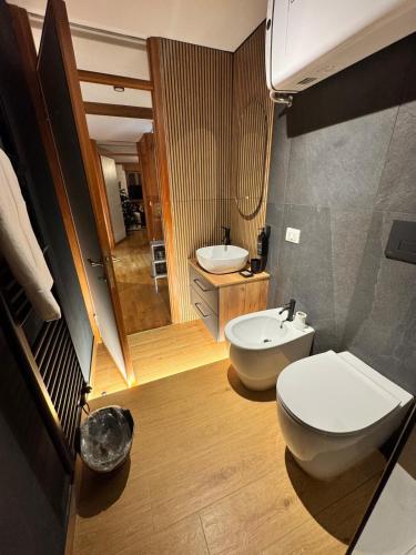 a bathroom with a white toilet and a sink at The Queen in the Snow in Courmayeur