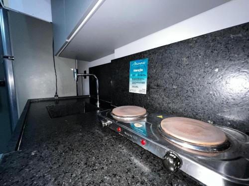 a bathroom with a counter with two toilets on it at Get One - Bessa in Tambaú