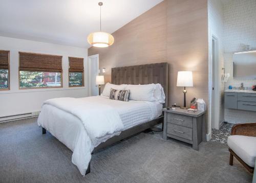 a bedroom with a large white bed and a bathroom at 2633 Kinnickinnick Rd., Unit E2 in Vail