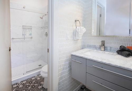 a white bathroom with a sink and a shower at 2633 Kinnickinnick Rd., Unit E2 in Vail