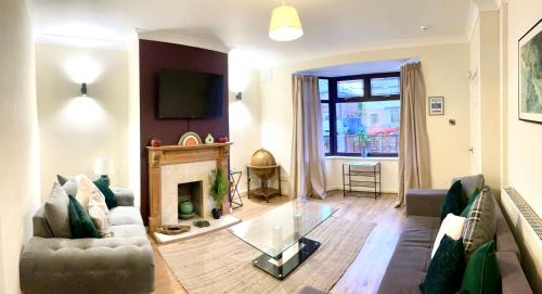 a living room with a couch and a fireplace at Long Eaton house sleeps 6 & double sofabed in Long Eaton