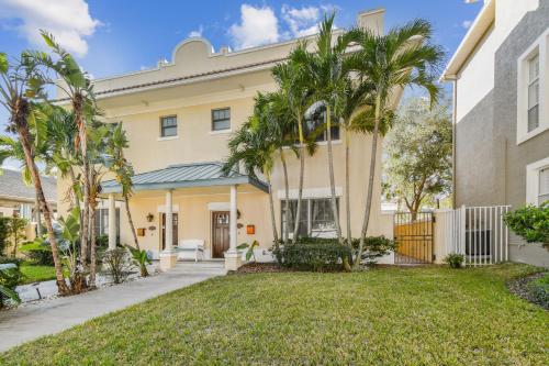 a house with palm trees in front of it at Cozy Hyde Park Home in Tampa