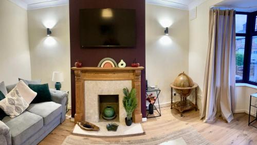 a living room with a couch and a fireplace at Long Eaton house sleeps 6 & double sofabed in Long Eaton