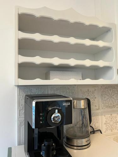 a kitchen counter with a coffeemaker on a counter at Eden Apartman Vrnjačka Banja in Vrnjačka Banja