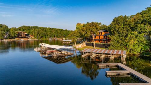 a dock on a lake with boats in the water at Sunset Beach Resort in Osage Beach