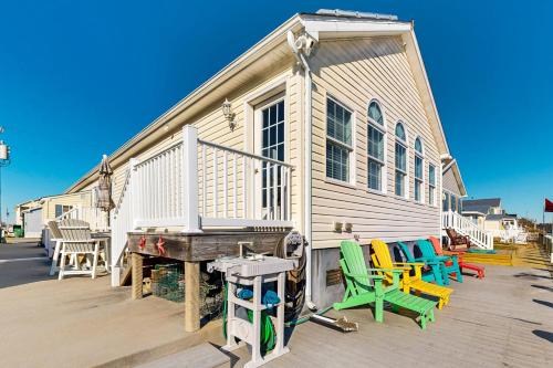 a group of colorful chairs sitting outside of a building at Swann Keys --- 37022 Blue Teal Rd in Selbyville