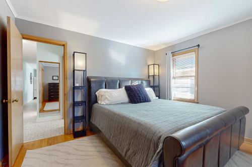 a bedroom with a large bed and a mirror at The Urban Oasis in Minneapolis