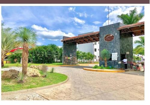 a gas station in a park with a palm tree at Casa La Fragata in Zihuatanejo