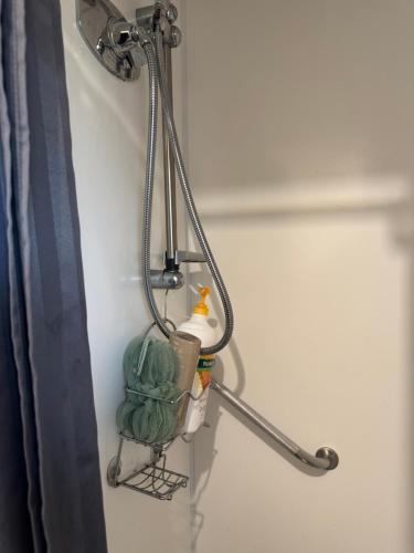 a towel rack on the wall of a bathroom at Surf, Play and Stay in Tairua