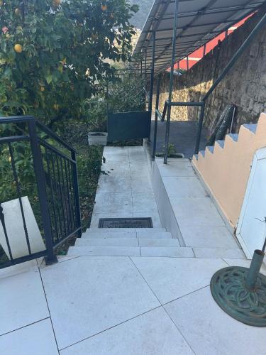 a set of stairs leading up to a building with a gate at Villa Miramare , Dobrota seafront in Kotor