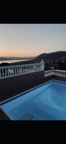 a swimming pool on the side of a white fence at Zoe's house Salamina in Salamís