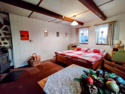 a living room with two beds and a fireplace at Chata Koza in Bublava