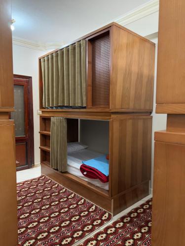a large wooden cabinet in a room at Al-Manara Hostel Siwa Oasis 2 in Siwa
