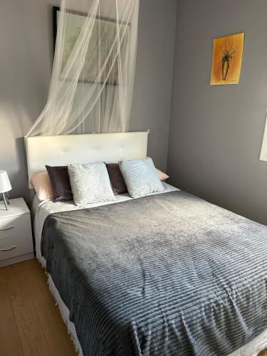 a bedroom with a bed with two pillows on it at Seaside cottage in Pobla de Montornés