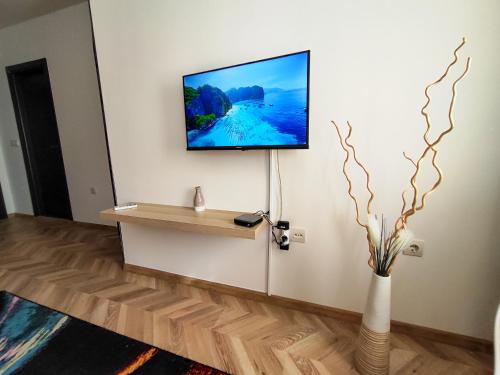 a living room with a tv on a wall at Nature Life, 200m to the Lift in Bansko