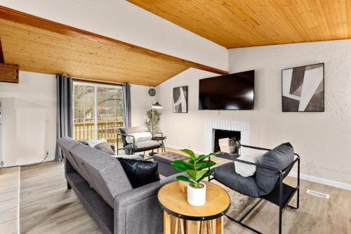 a living room with two couches and a fireplace at Comfort Cabin - 2BD Family Getaway in Creve Coeur in Creve Coeur