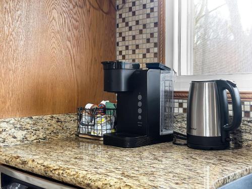 a coffee maker on a counter in a kitchen at Comfort Cabin - 2BD Family Getaway in Creve Coeur in Creve Coeur