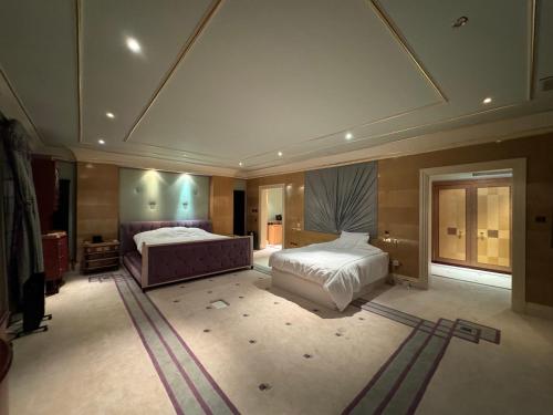 a large bedroom with two beds and a ceiling at The Bishops in London