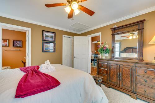a bedroom with a large bed with a dresser and a mirror at 2 Mi to Ski Resort Beech Mtn Home with Fire Pit! in Beech Mountain