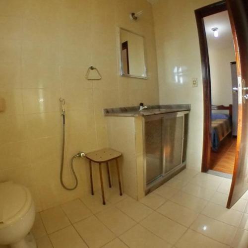 a bathroom with a shower and a toilet and a sink at Casa da Olga Itatiaia in Itatiaia