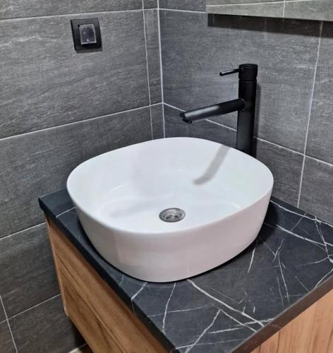 a white sink on a counter in a bathroom at Apartman B64 Residence Hill Kopaonik in Kopaonik