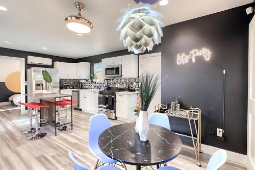 a kitchen and dining room with a table and chairs at Stylish 3BR East Side Retreat w Patio & BBQ in Austin