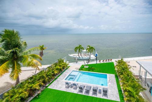 an aerial view of the ocean and a swimming pool at Ritaville - Monthly Rental in Stock Island