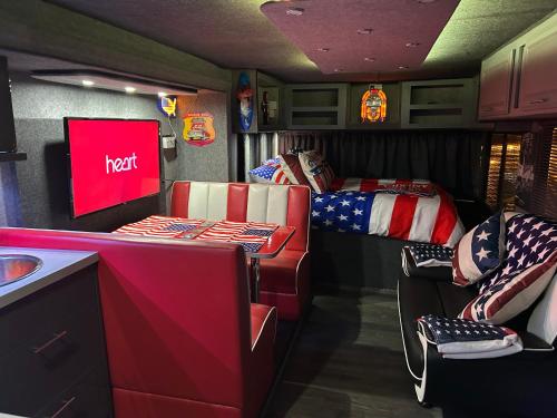 an rv with two bunk beds and a kitchen at American rv glamping with hot tub in St Asaph