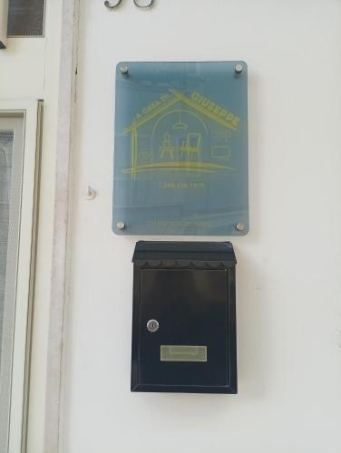 a sign on the side of a building with a box at A Casa di Giuseppe in Manfredonia