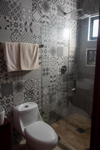 a bathroom with a toilet and a shower at 2br/2ba Condo 1 block to ocean! - Unit 4 in Mazatlán