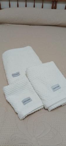 two white towels sitting on top of a bed at A Casa di Giuseppe in Manfredonia