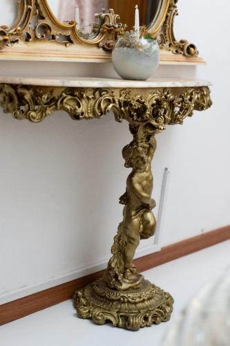 an ornate gold console table with a mirror at To Be Home in Bomarzo