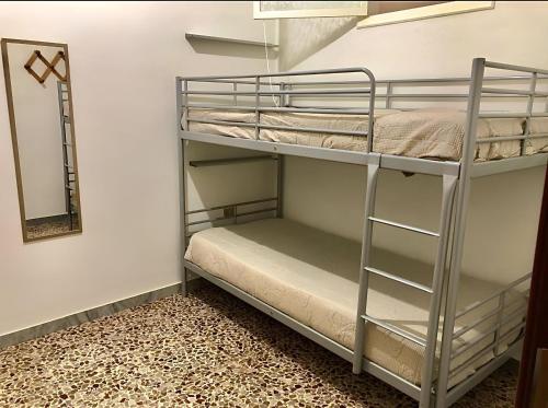 a bunk bed room with two bunk beds and a mirror at A Casa di Giuseppe in Manfredonia