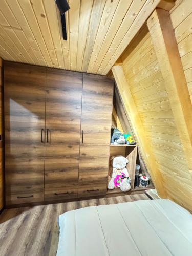 a bedroom with a large wooden closet and a bed at Villa Leka in Siničane