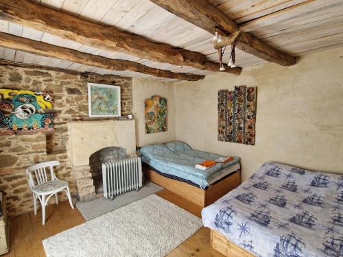 a bedroom with a bed and a stone wall at Вила 'Гнездото', Villa 'The nest', Rhodope mountains, Banite in Vishnevo