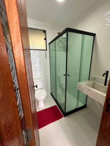 a bathroom with a glass shower and a toilet at Recanto do Leste in Angra dos Reis