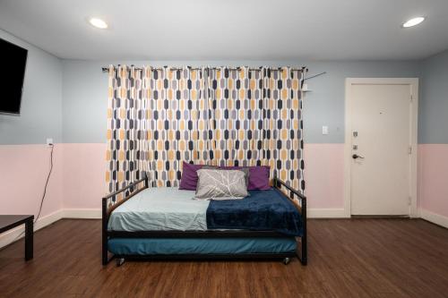 a bedroom with a bed with a curtain and a bedskirtspectspectspectspects at Chic & Cozy 1BR Apt with Free Parking & King Bed in Houston