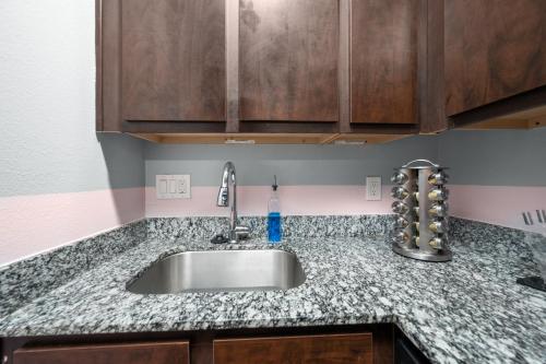 a kitchen counter with a sink in a room at Chic & Cozy 1BR Apt with Free Parking & King Bed in Houston