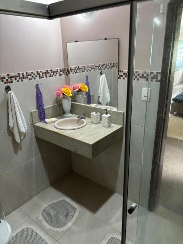 a bathroom with a sink and a mirror at Casa Barra Mar in Saquarema