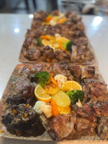 a plate of food with vegetables and other foods at Hotel Kulla e Arte in Razëm