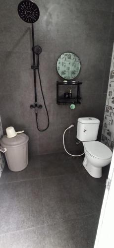 a bathroom with a shower and a toilet and a sink at Villa Kanaya in Sukapura
