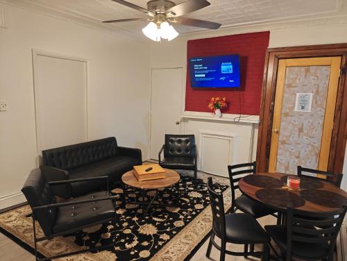a living room with a couch and a table and chairs at JSQ Apartment, 5 Mins from PATH Station in Jersey City